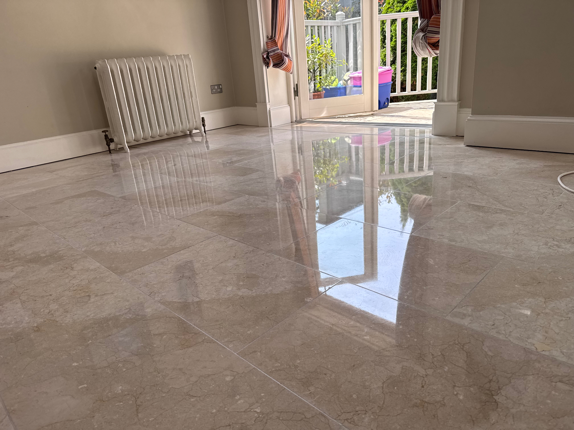 Professional rotary floor buffer polishing a marble tiled floor
