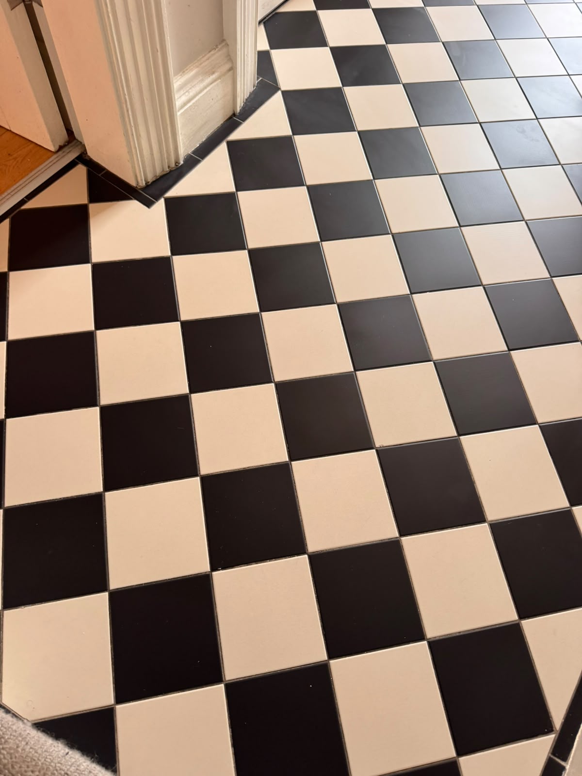 Freshly deep-cleaned ceramic tile floor with bright, refreshed grout lines